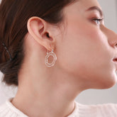 Close up of Minimalist 18k gold-plated circular hoops called Golden Glow, lightweight and perfect for everyday wear with a modern, elegant design.